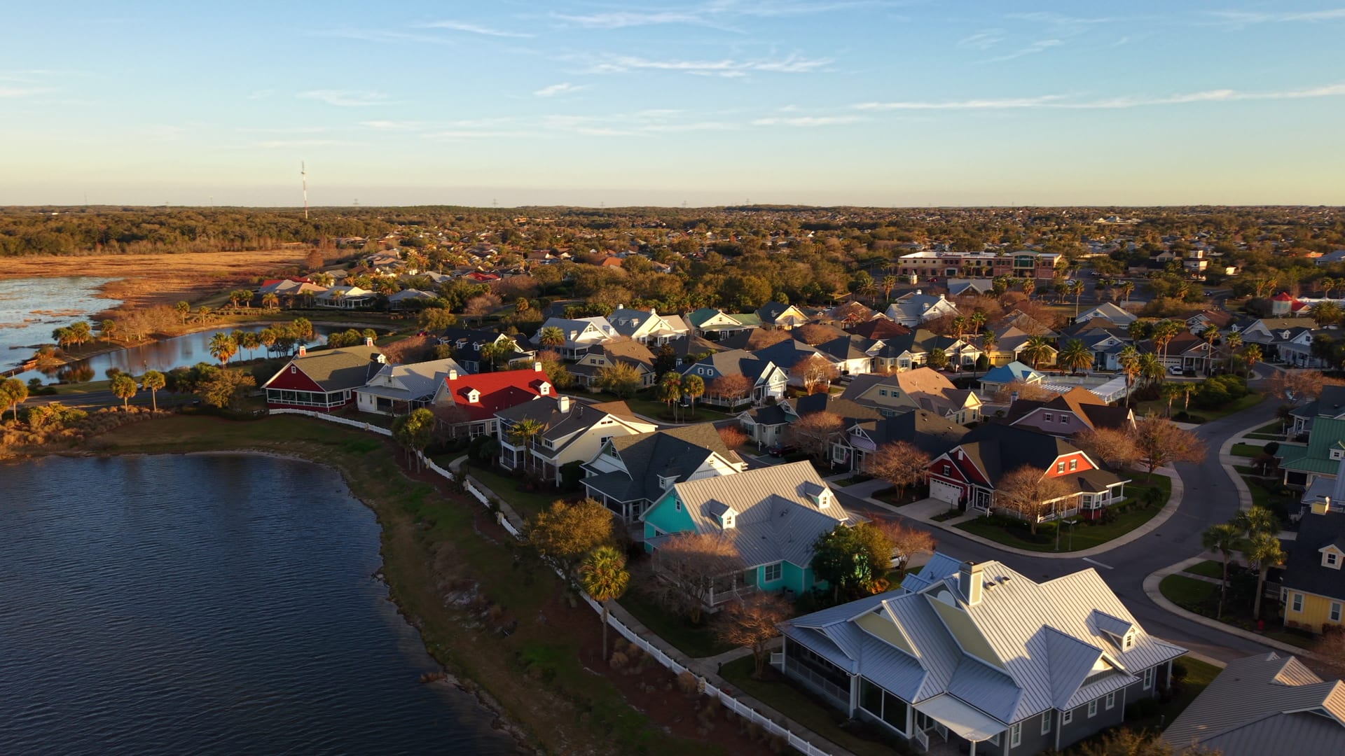 Golden-hour aerial of a coastal residential community